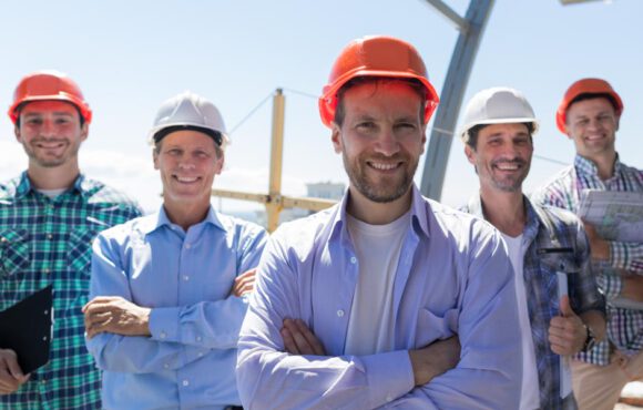 Builders Team Leader Over Group Of Apprentices At Construction Site